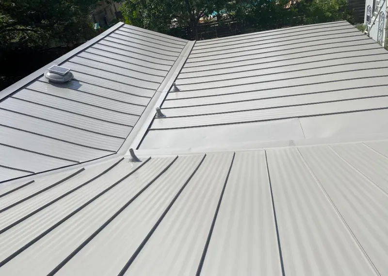 Solar attic fan installed on a metal roof for Roof Ventilation in Yazoo City